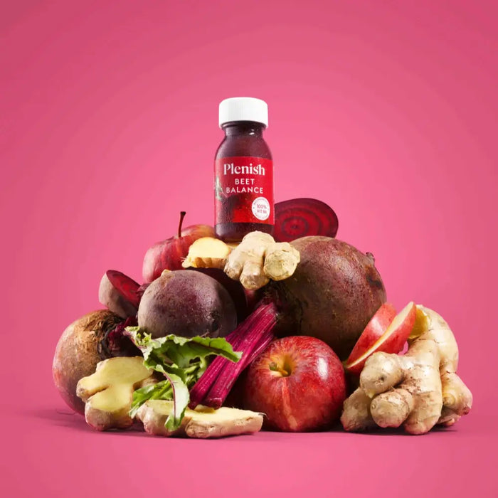 Plenish - Beet Balance Vitamin B6 Health Shot 60ml on a pile of betters, apple and ginger on a beet purple background