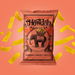 Howdah Bombay Sweet Chilli ancient grain chips packaging on a pink background with yellow chips.