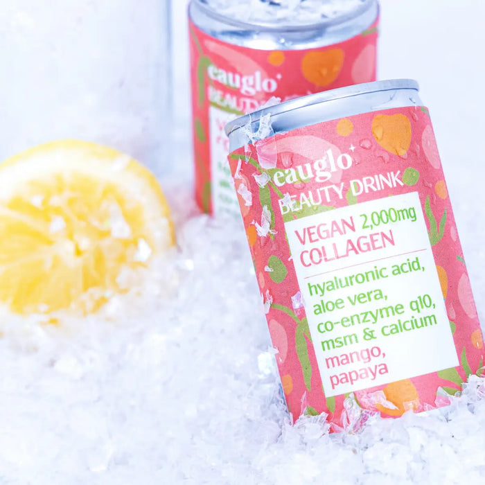 Eauglo - Mango and Papaya Beauty Drink 24 x 2000mg Vegan Collagen. Lifestyle image of 2 cans in crushed ice with some lemon.