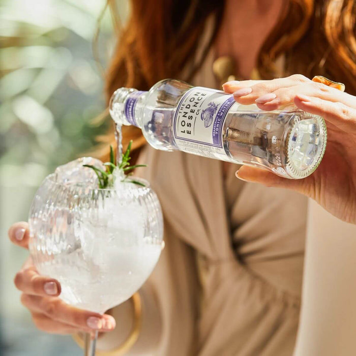 Wholesale London Essence - Grapefruit & Rosemary Tonic Water 24 x 200ml Lifestyle Shot. Tonic water being poured into a glass with ice.