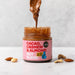 Wholesale Nut Blend - Cacao, Cashew & Almond Butter 6 x 200g lifestyle shot. Spoonful of butter lifted out of the jar