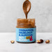 Wholesale Nut Blend - Cinnamon, Hazelnut & Almond Butter 6 x 200g lifestyle shot. Spoonful of butter lifted out of the jar