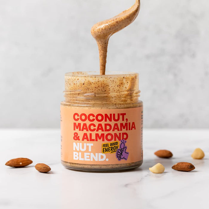 Nut Blend - Coconut, Macadamia & Almond Butter 6 x 200g lifestyle shot. Spoonful of butter lifted out of the jar