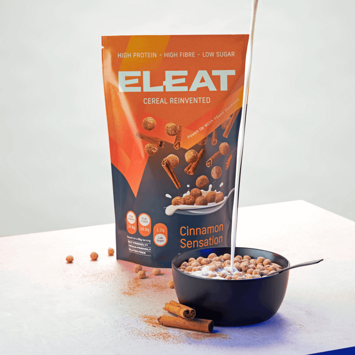 Wholesale Eleat Cereal Cinnamon Sensation 250g  next a bowl full of the cereal with milk being poured
