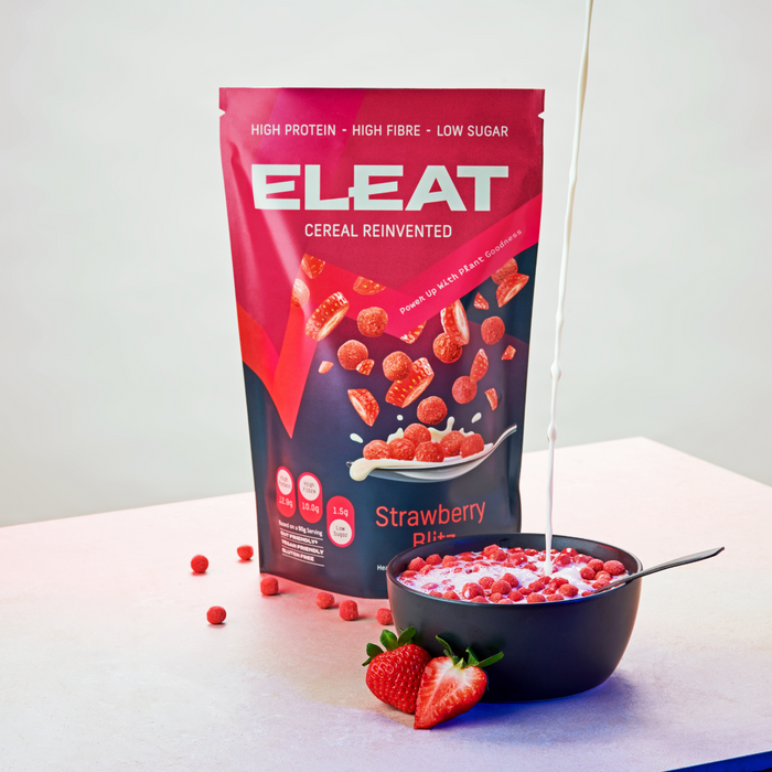 Eleat Cereal Strawberry Blitz 250g Pouch next to a bowlful of the cereal with milk being poured ontop 